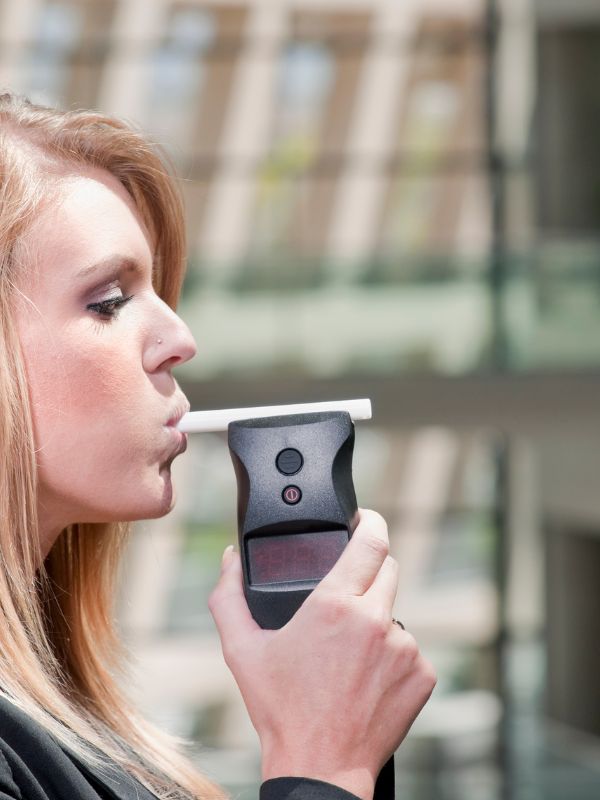 Breath & Blood Test A woman taking a breathalyzer after being pulled over for a DUI in Columbus