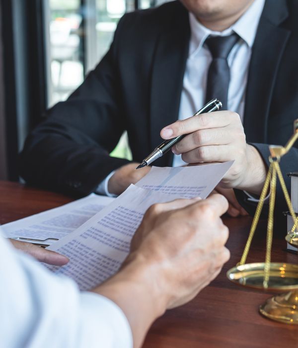 Ohio Criminal defense attorney, Nathan Akamine, reviewing evidence with a client at his office.