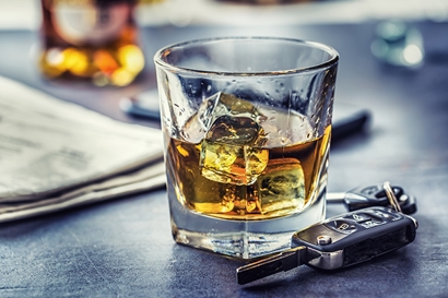 dui a glass of alcohol on a bar next to a set of car keys