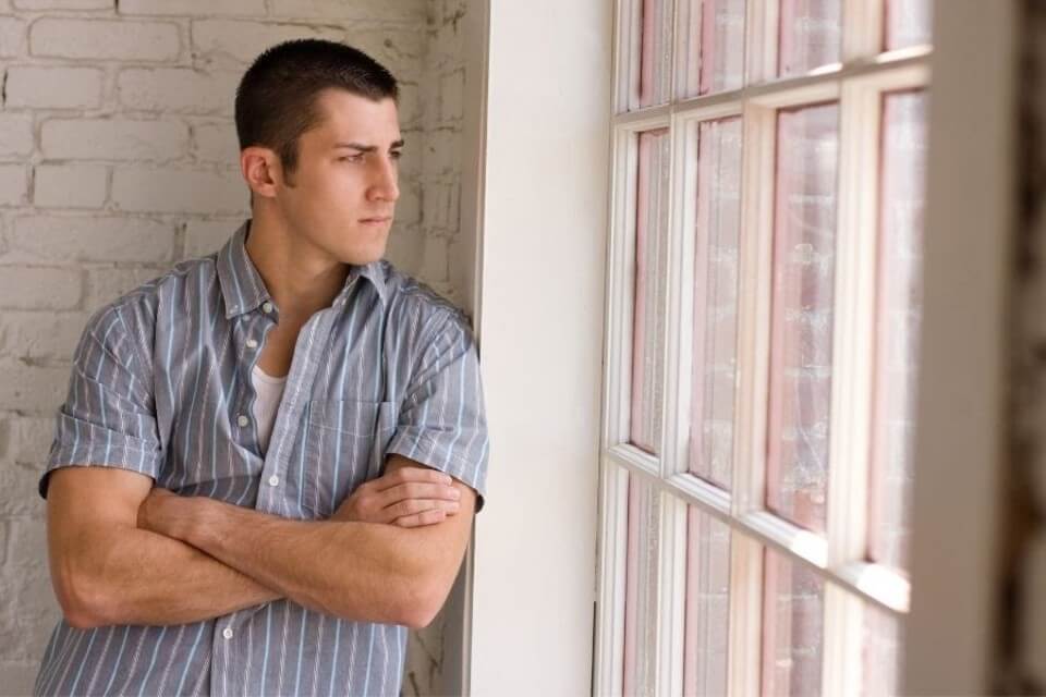 a man staring out the window after violating probation